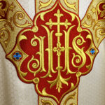 Embroidered liturgical chasuble in ecru with IHS symbol